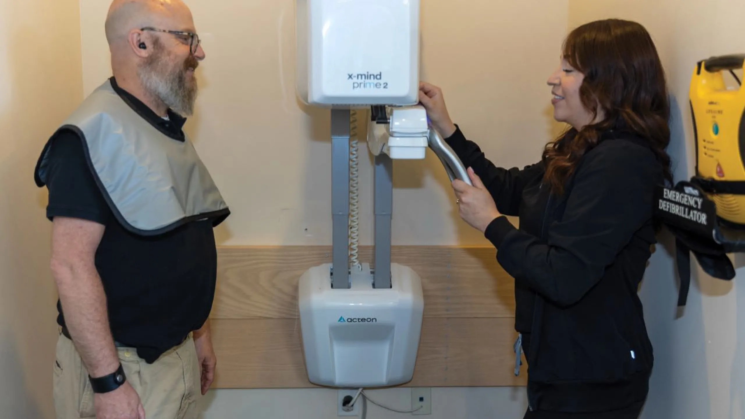 A patient being x-rayed by a dental assistant