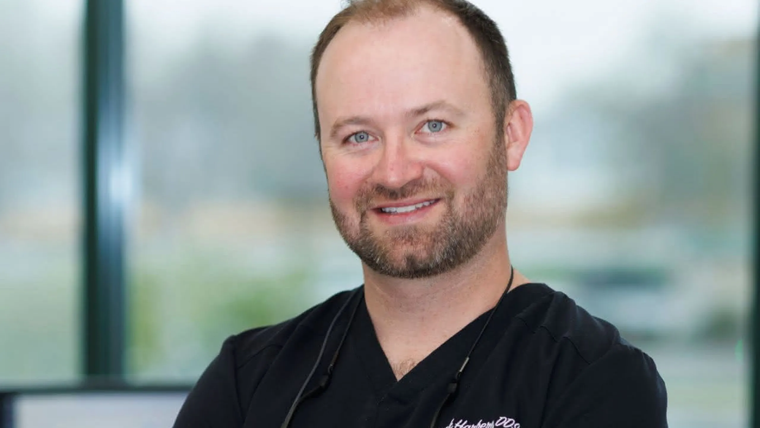 Dr. Harberg in front of a window
