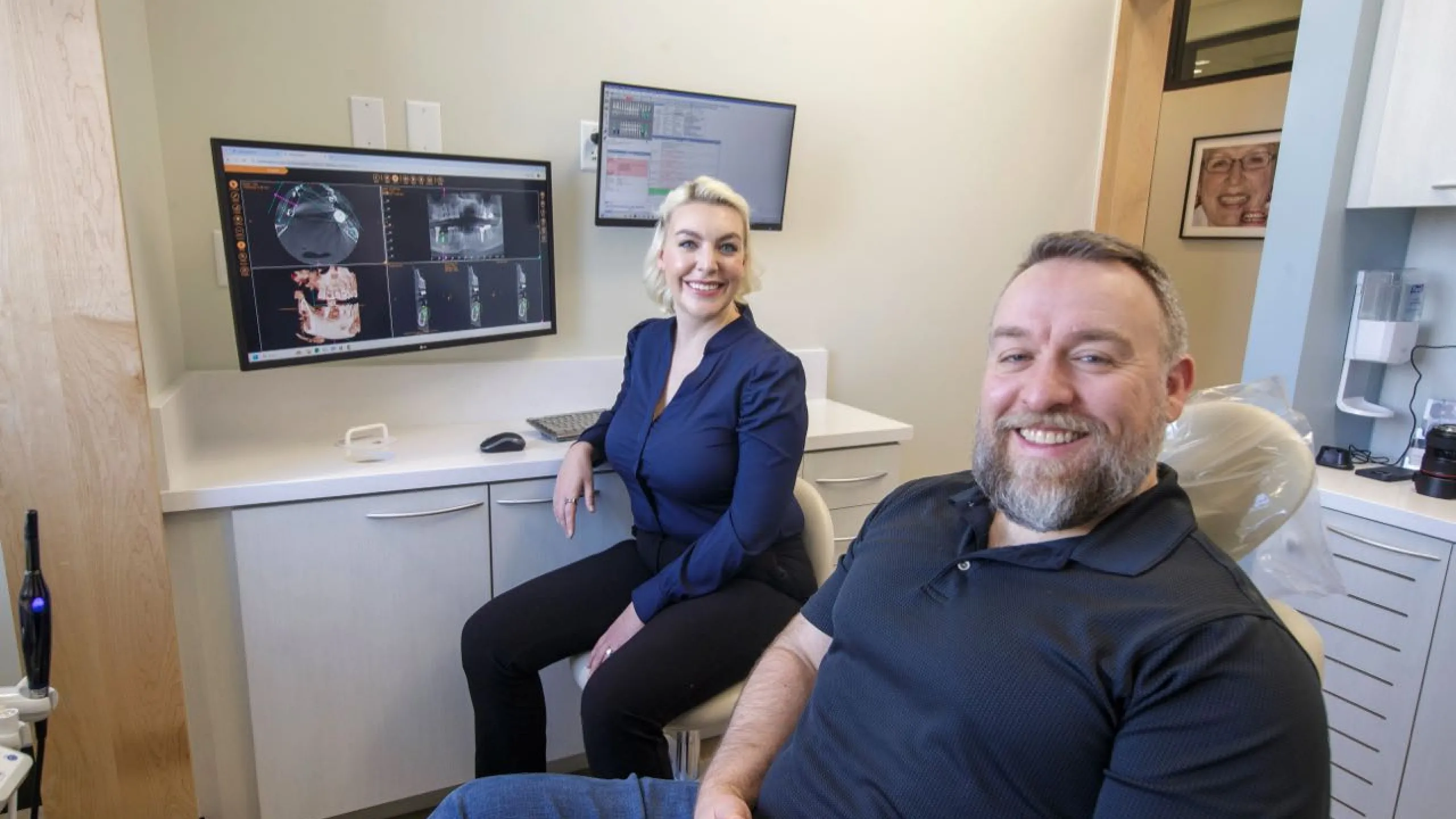 Dr. Sesson and a patient smiling in a dental suite