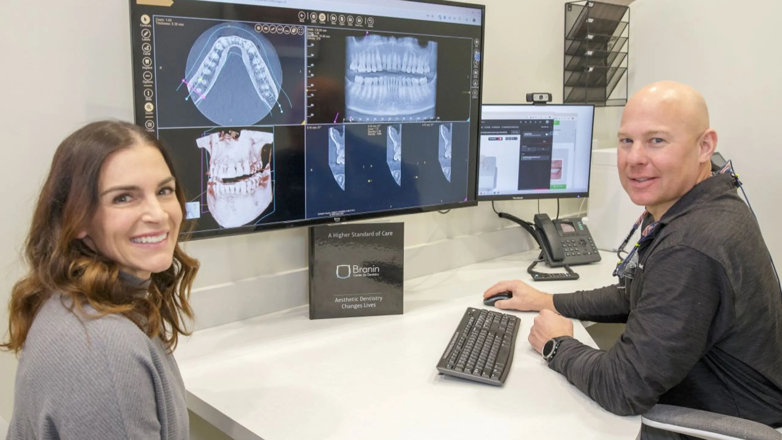 Dr. Dudley and a patient review x-rays on a compter monitor