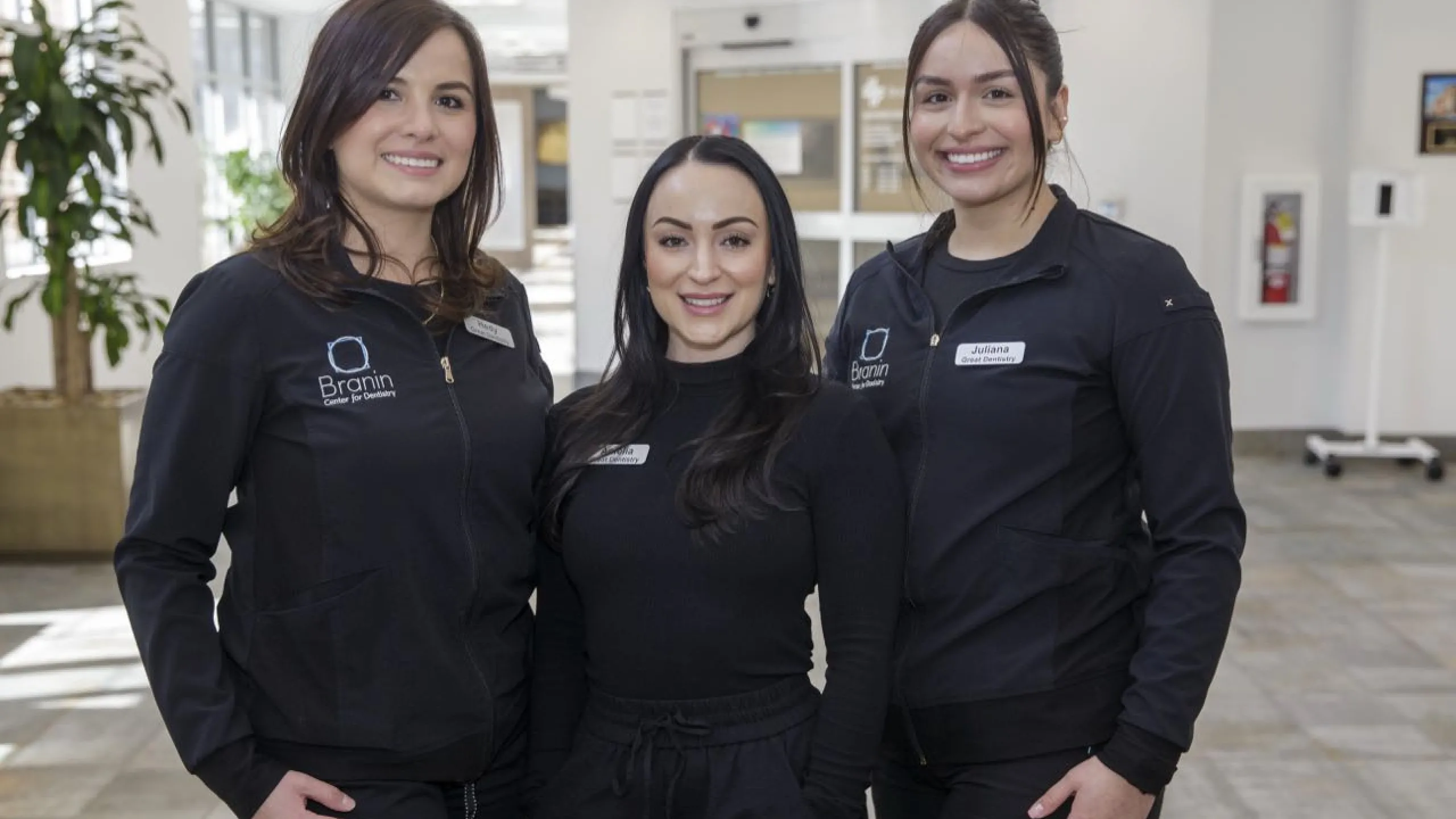 Three staff members standing in the lobby