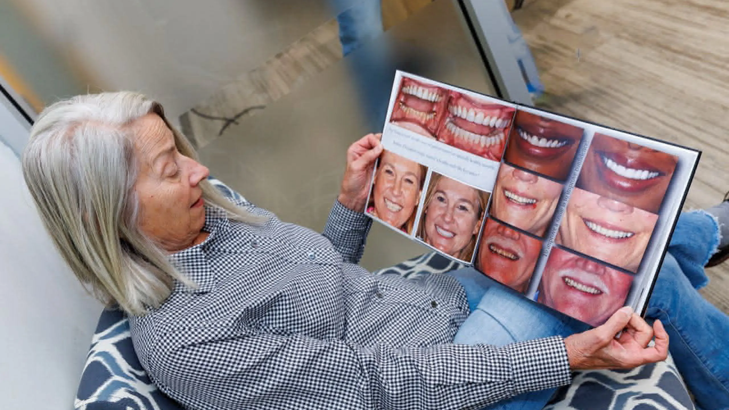 Patient looking at a book with smile examples