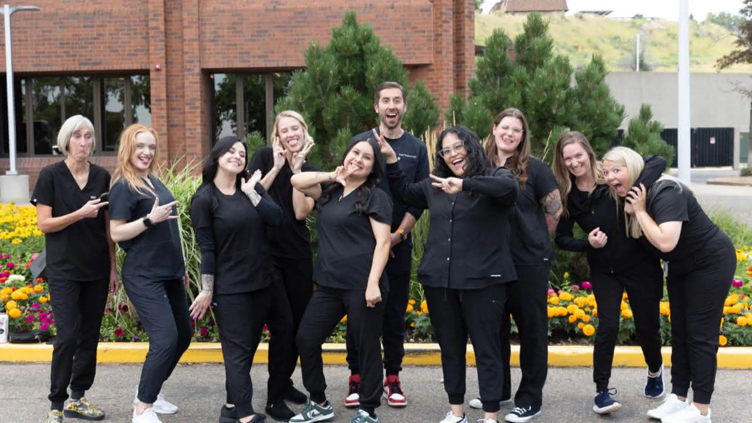 The team at Golden striking interesting poses in front of the office