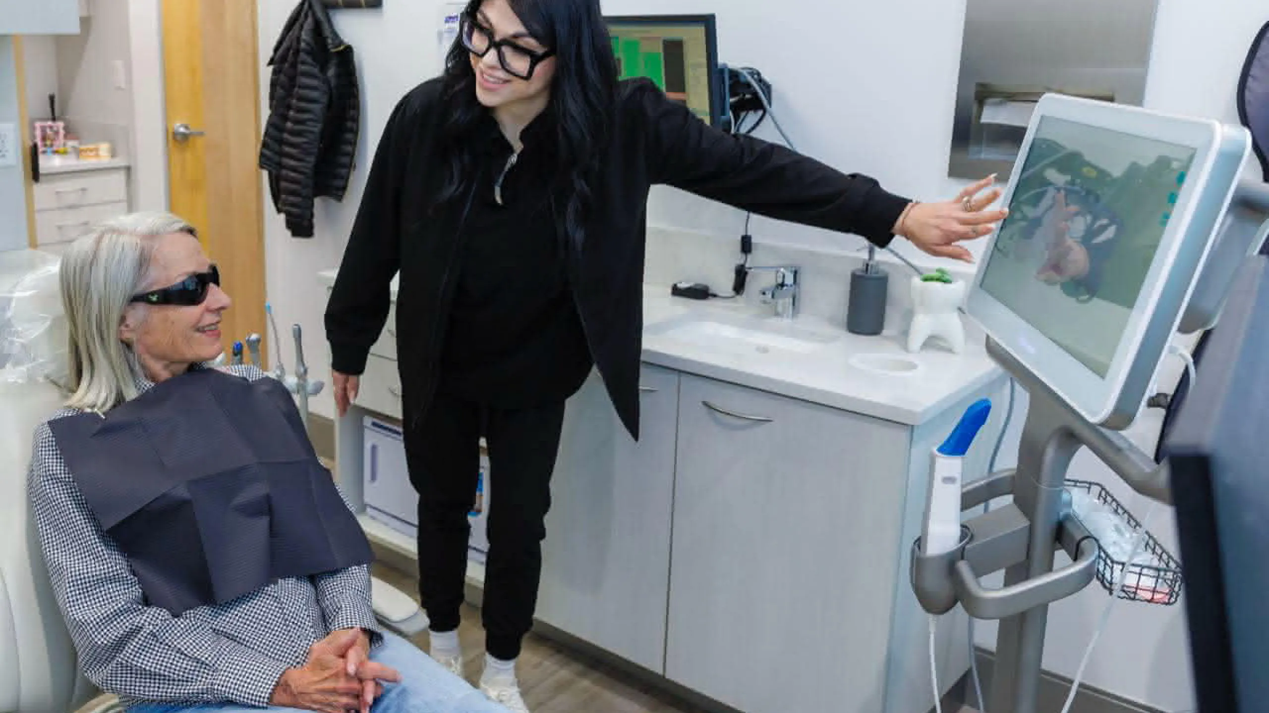 A person explaining a dental procedure to a patient
