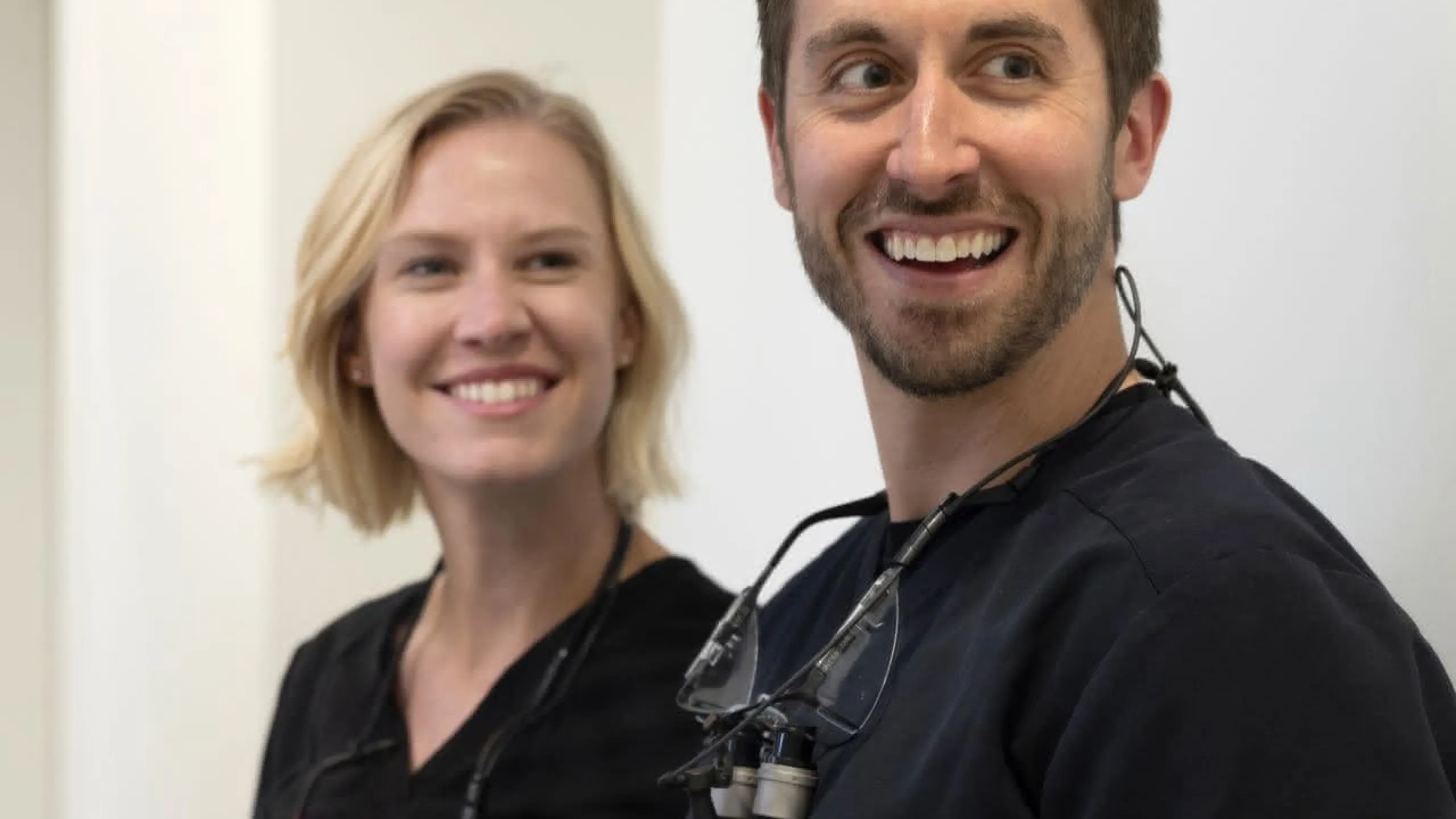 Two dentists smiling back at the camera