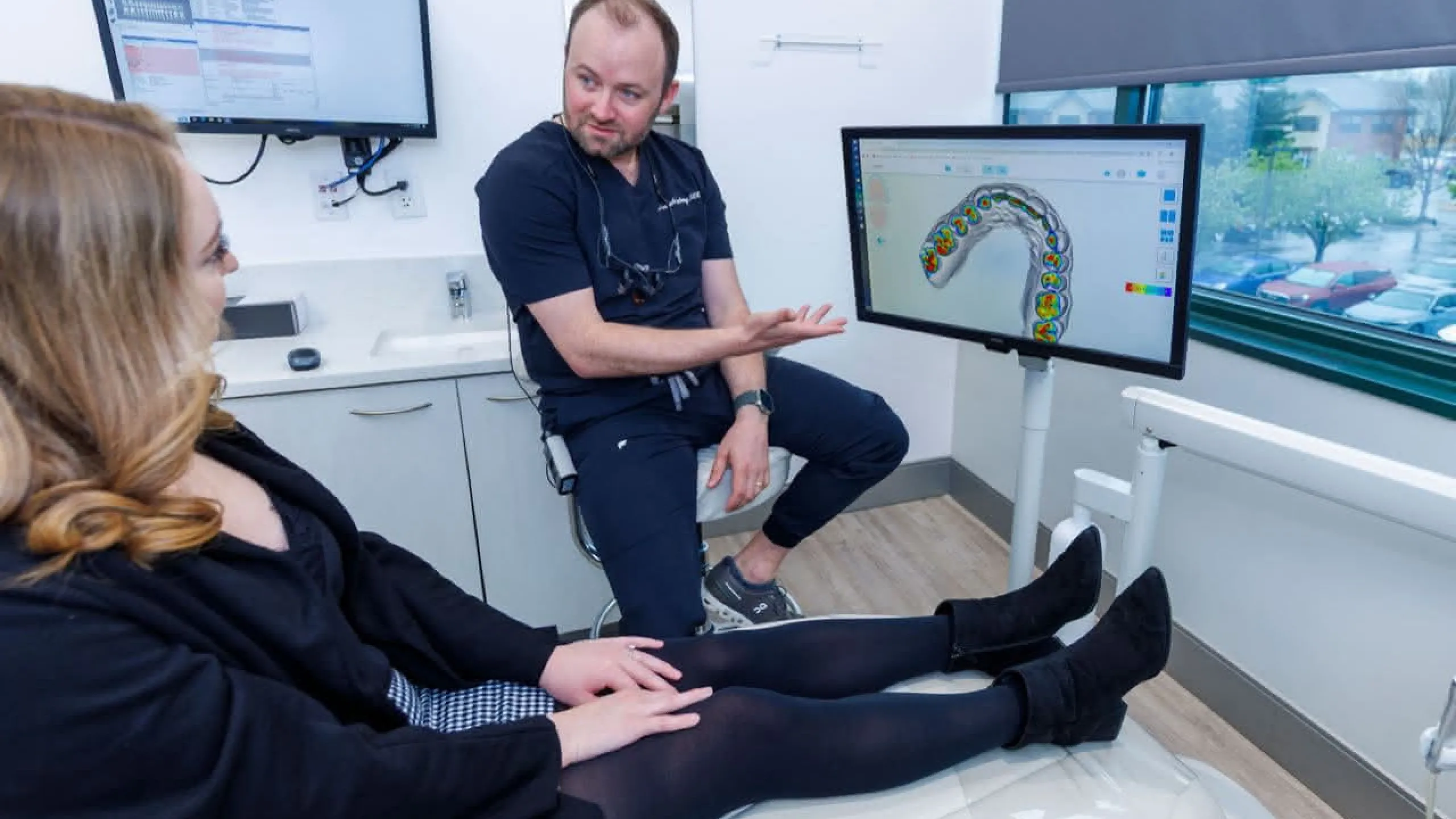 Dr. Harberg in front of a monitor explaining a procedure