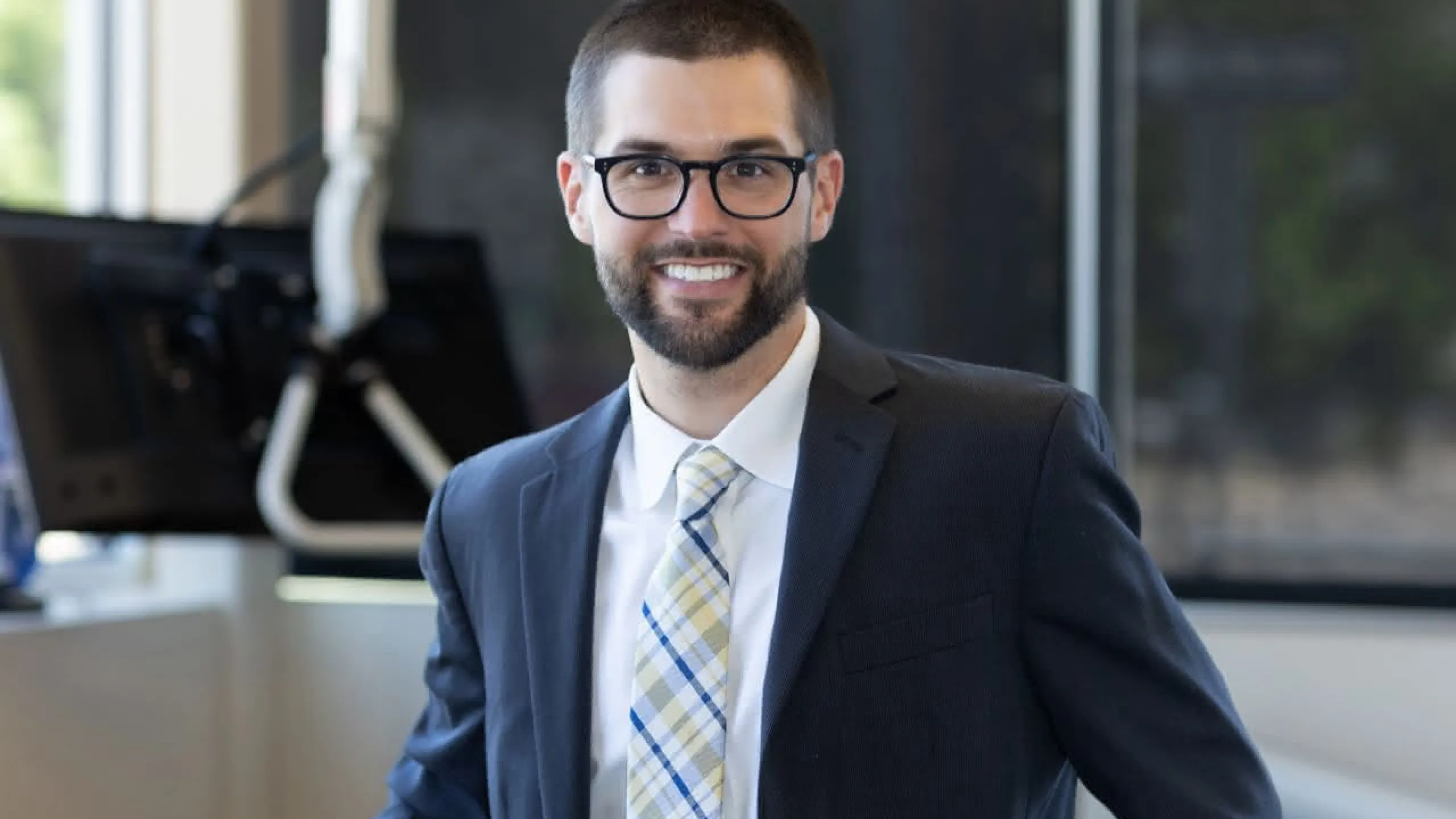 Dr. Adam Staffen in a suit smiling