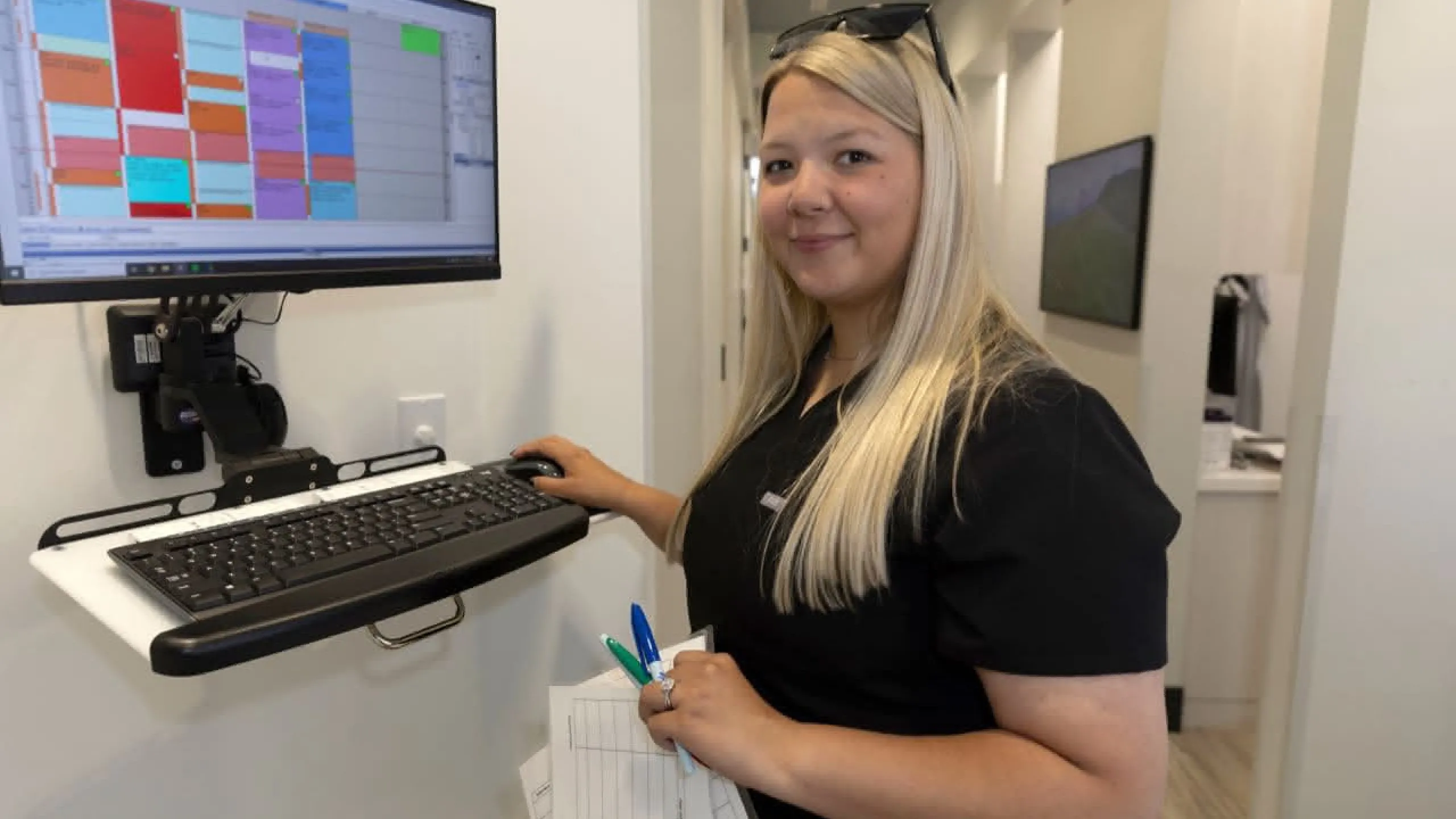 A staff member reviewing schedules at a standing desk