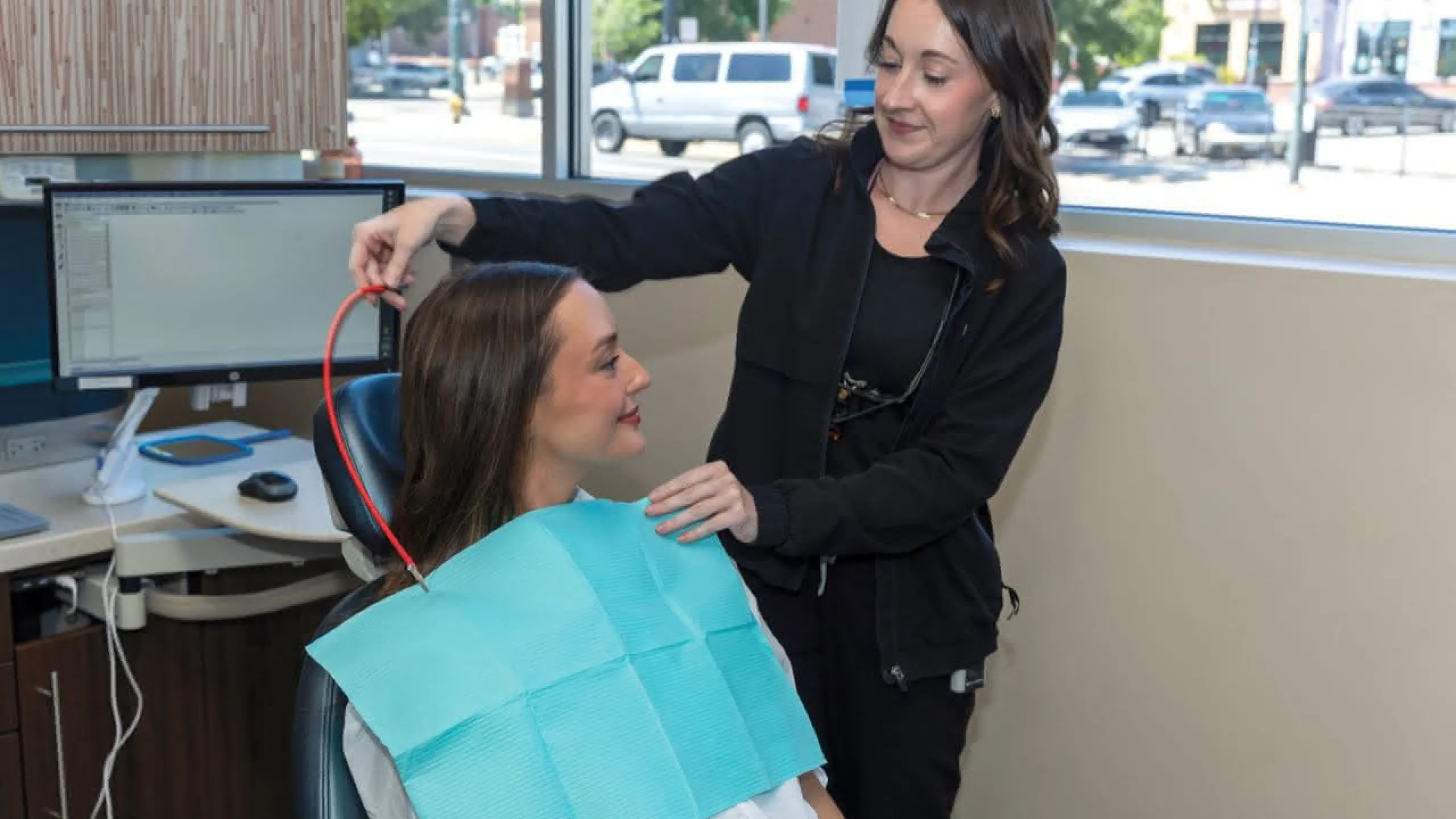 Patient in a chair with a blue bib