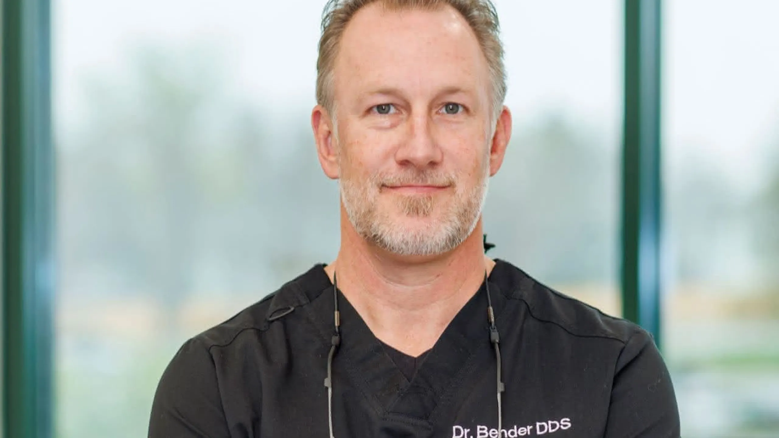 Dr. Bender in front of a window