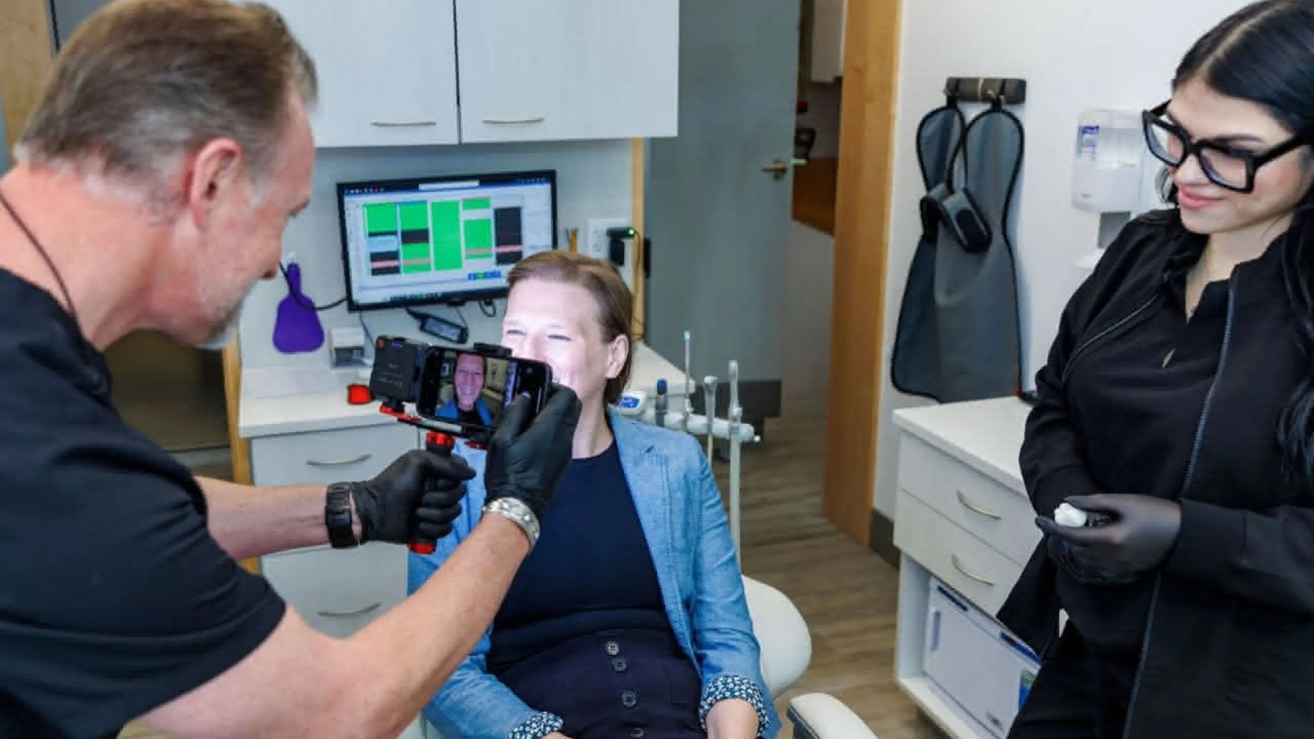 Dr. Bender and staff taking a photo of a smile