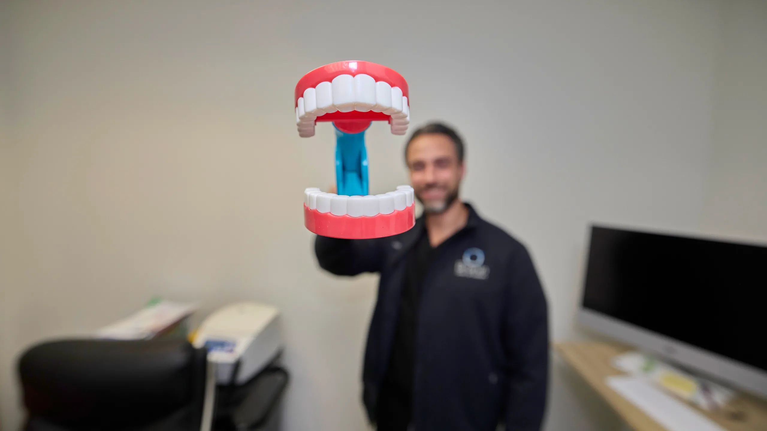 Dr. Rogers holding fake teeth.