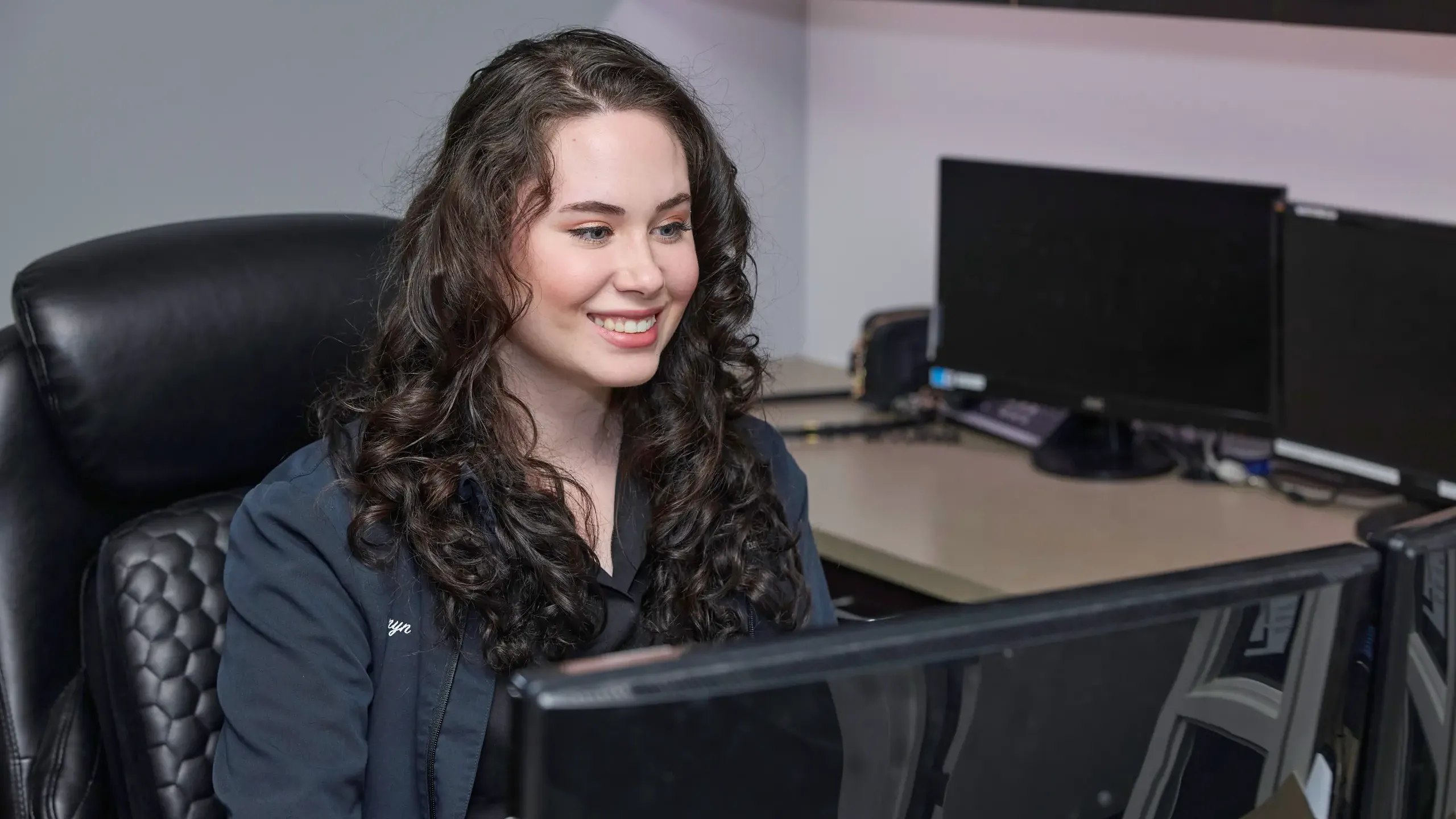 A team member looking at a computer monitor