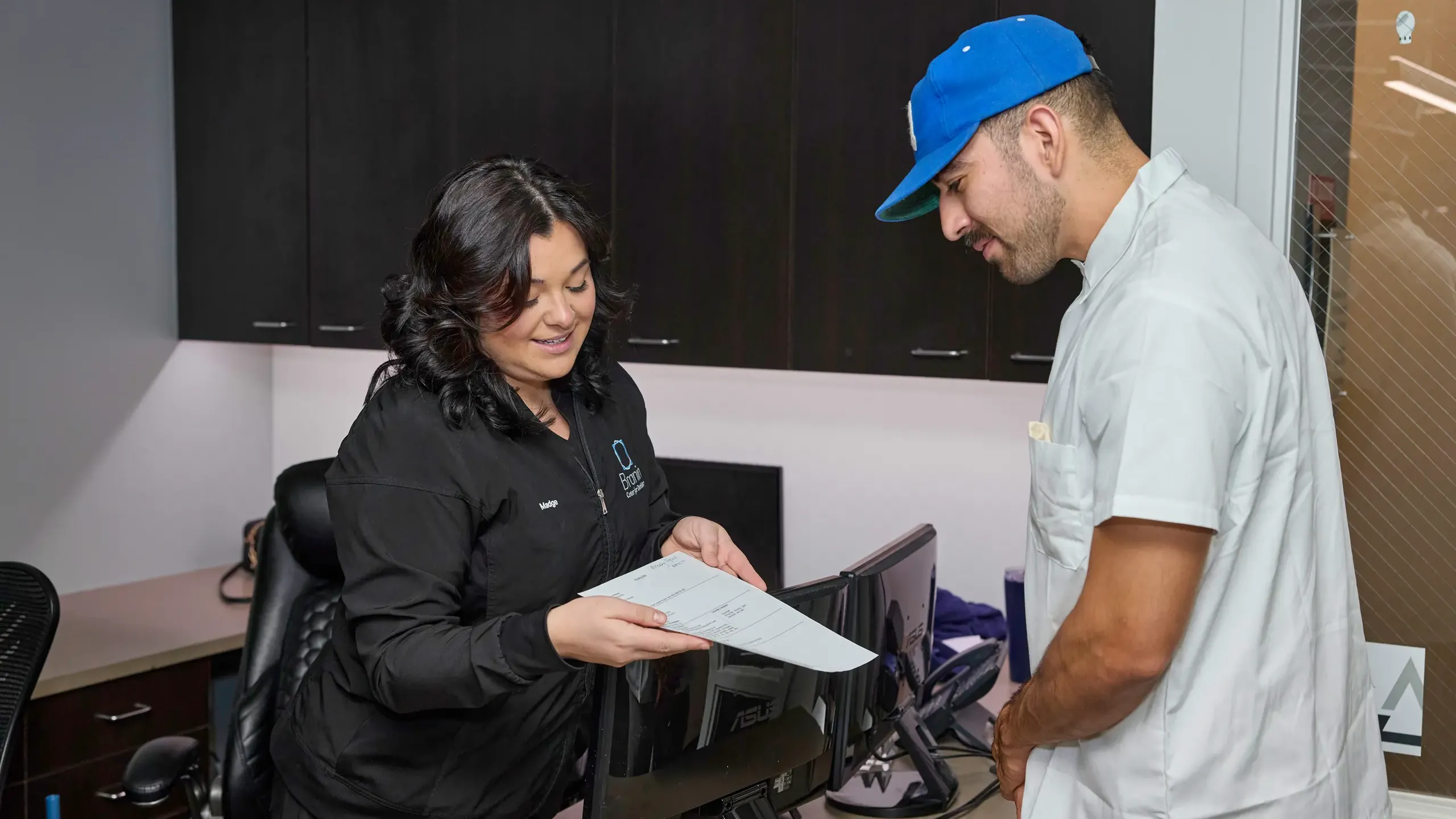 Front desk staff showing a patient paperwork