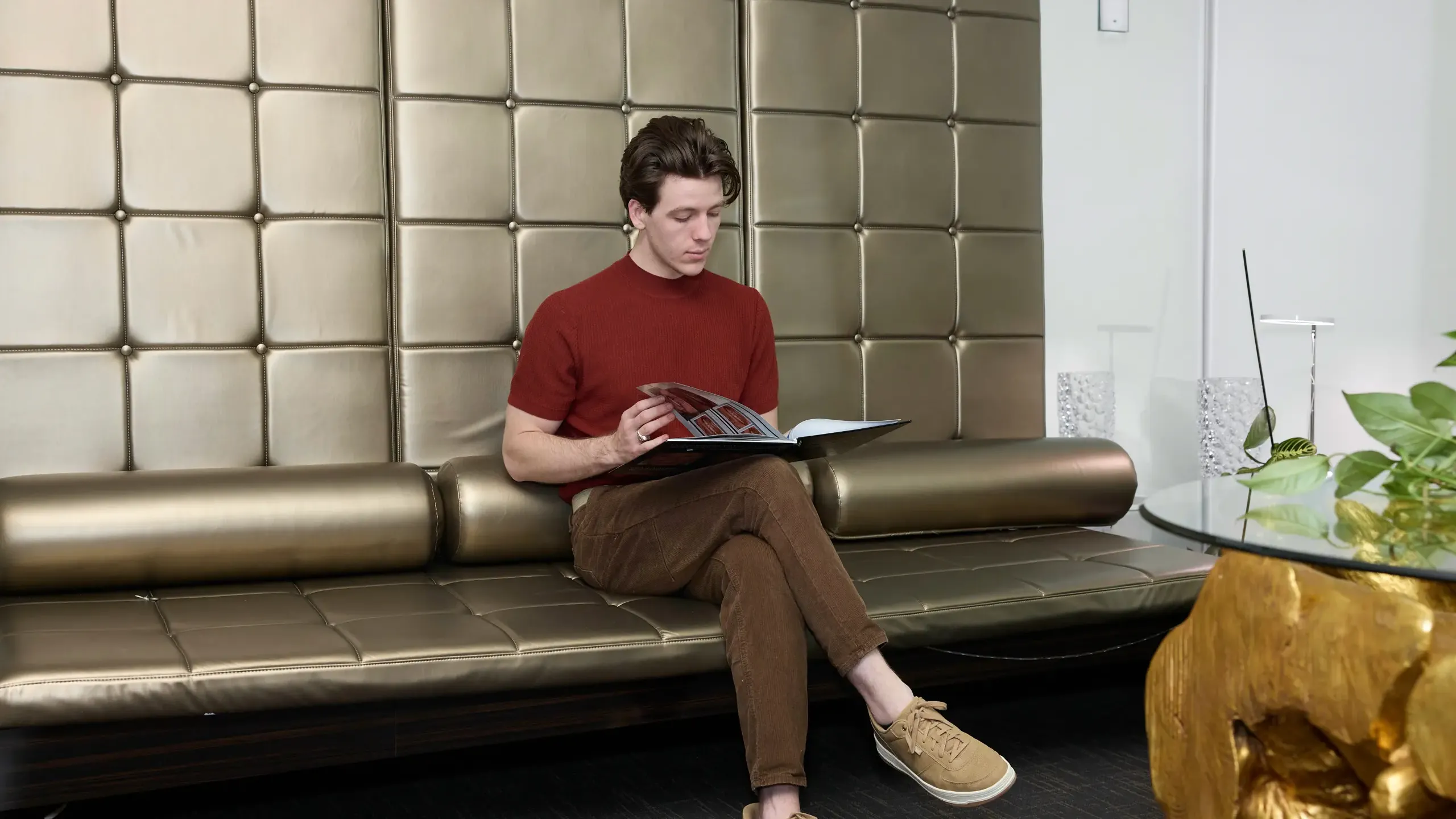 A person reading a book on a couch