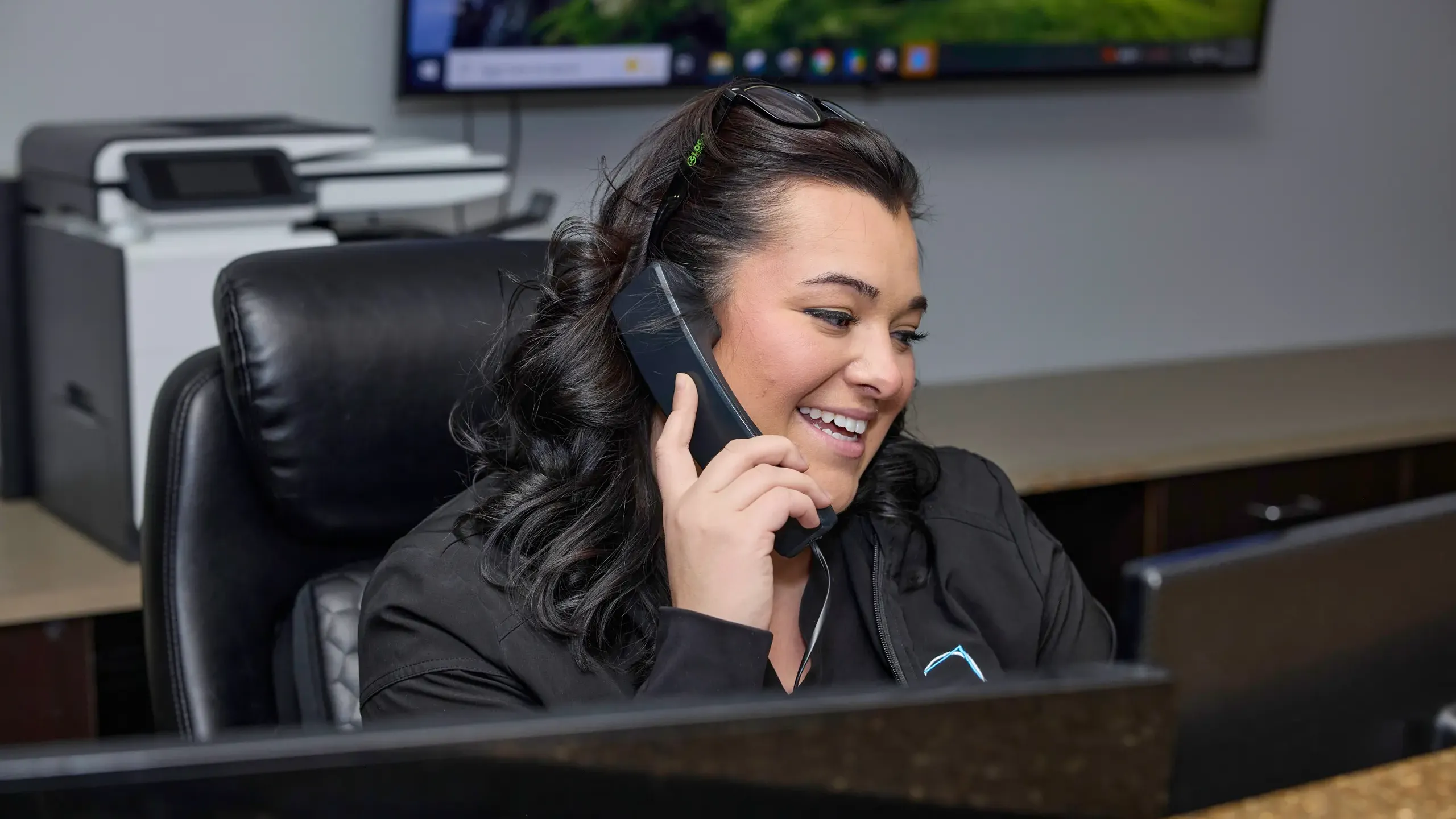 A team member at front desk on the phone