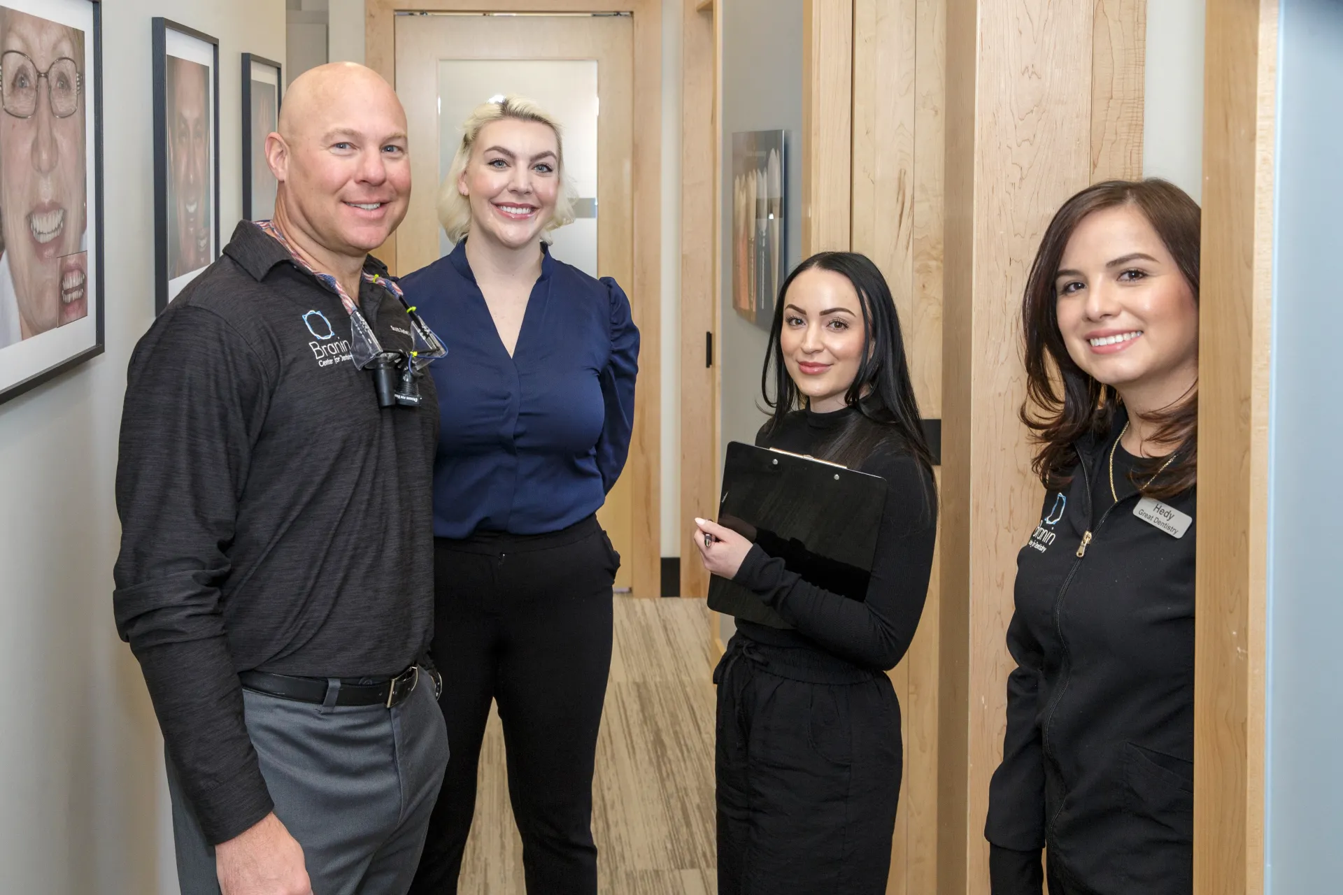 Dr. Branin smiing in the hallway with a couple other employees