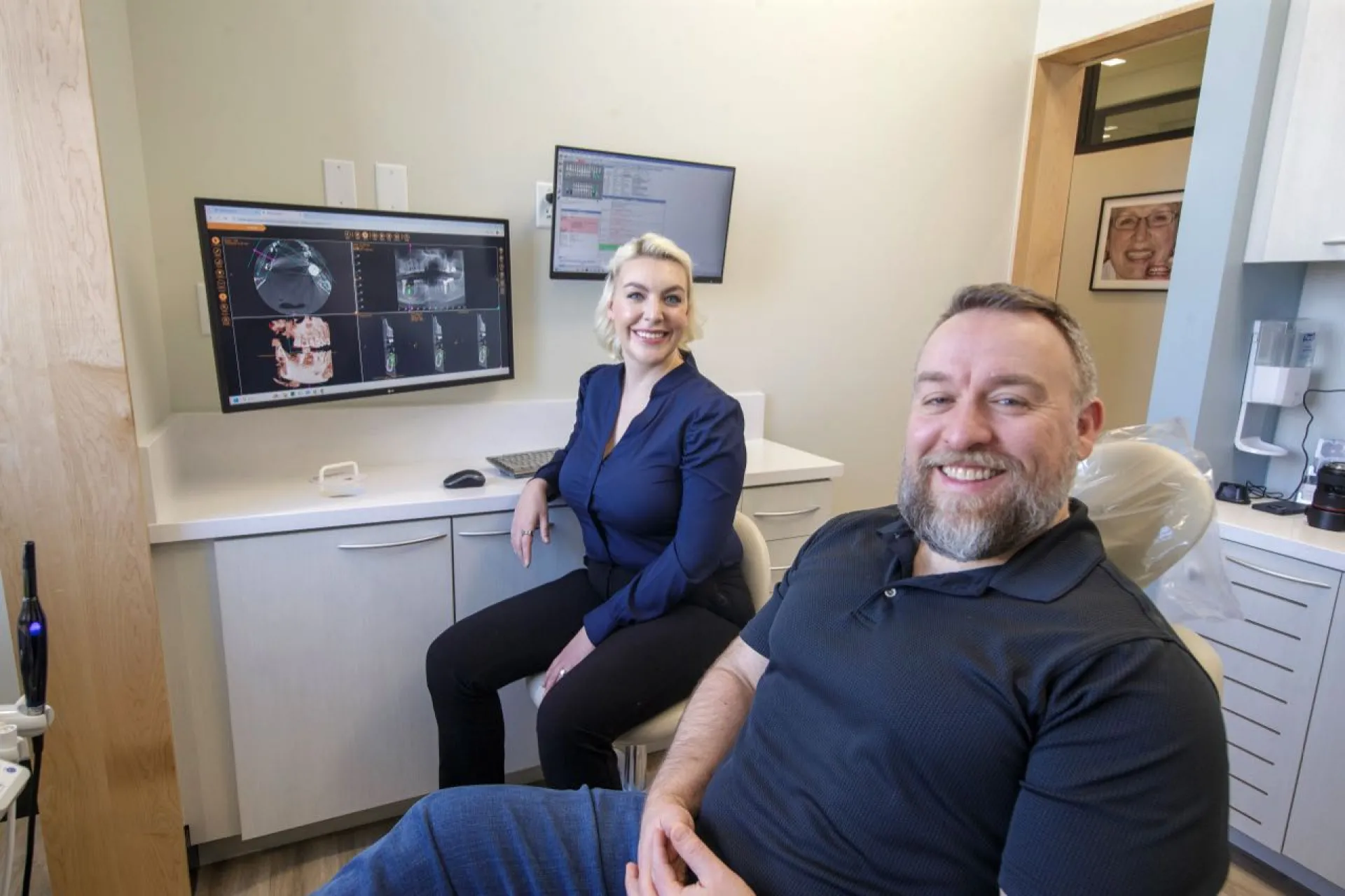 Dr. Sesson and a patient smiling in a dental suite