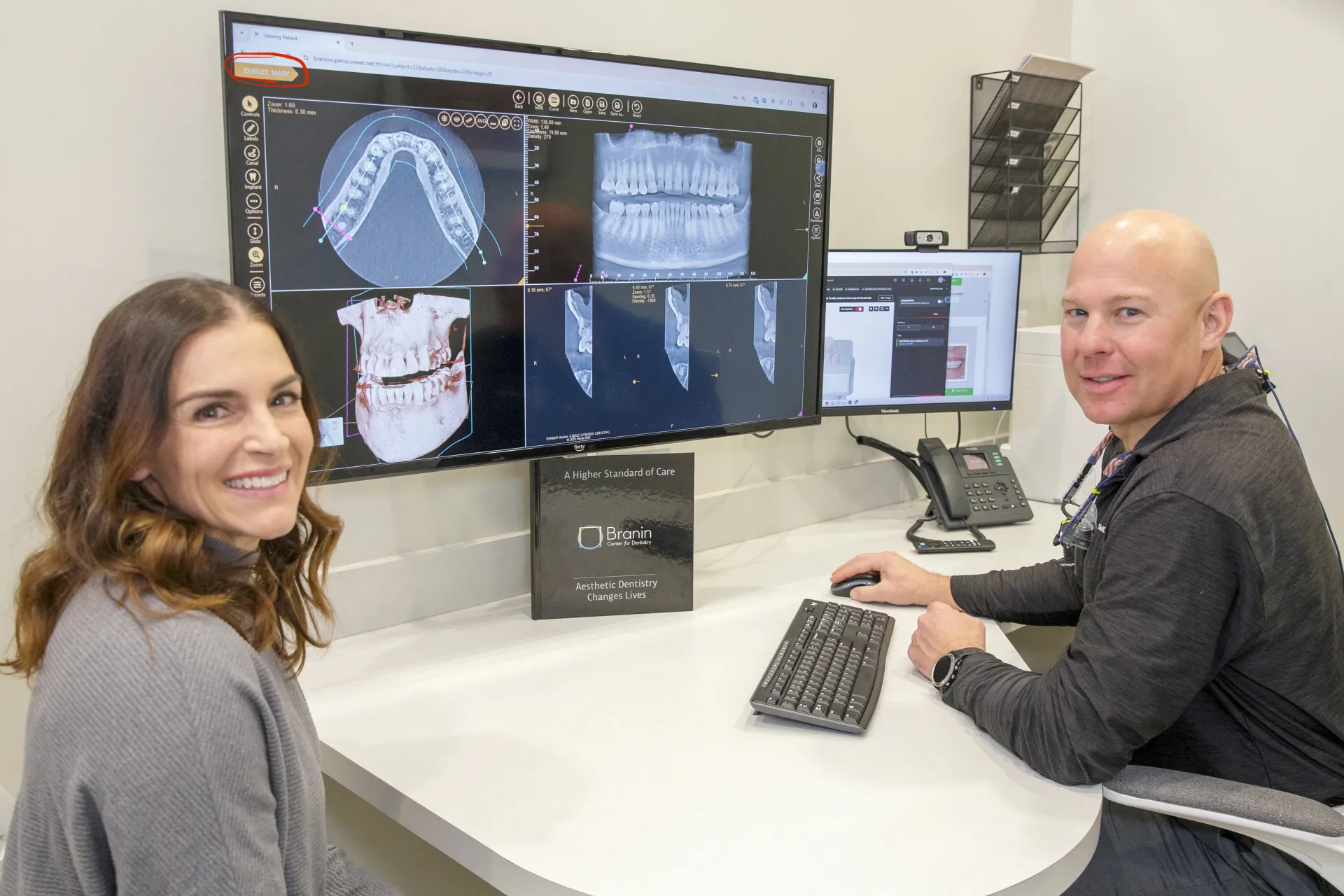Dr. Dudley showing a patient X-rays of their teeth