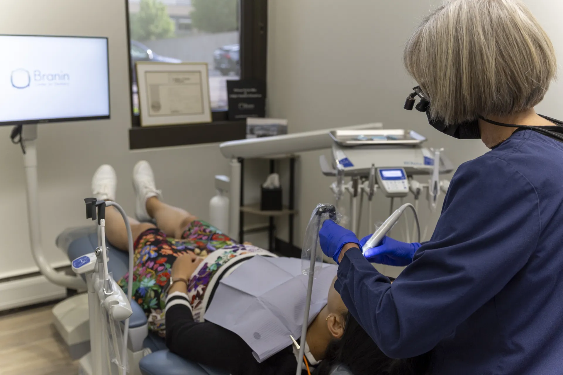 Hygienist Jacynthe Curtis cleaning a patient's teeth.