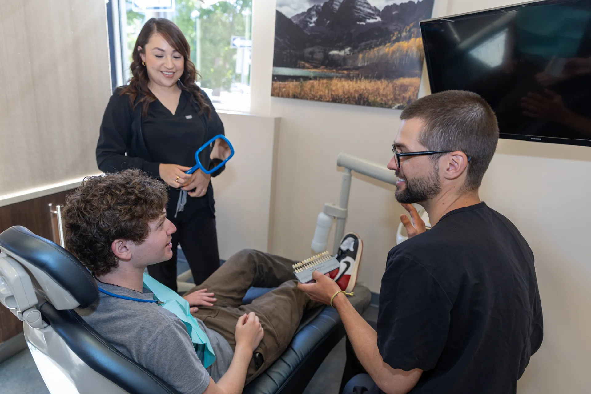 Dr. Staffen showing a patient different tooth colors