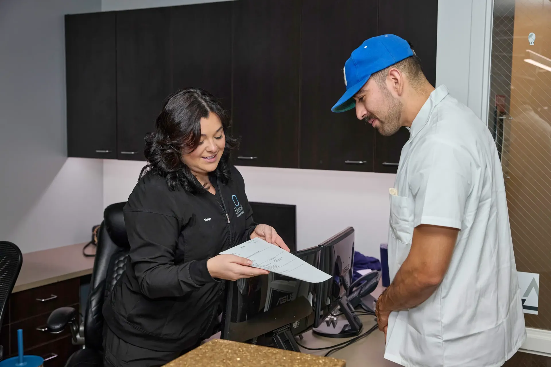 Front desk staff showing a patient paperwork