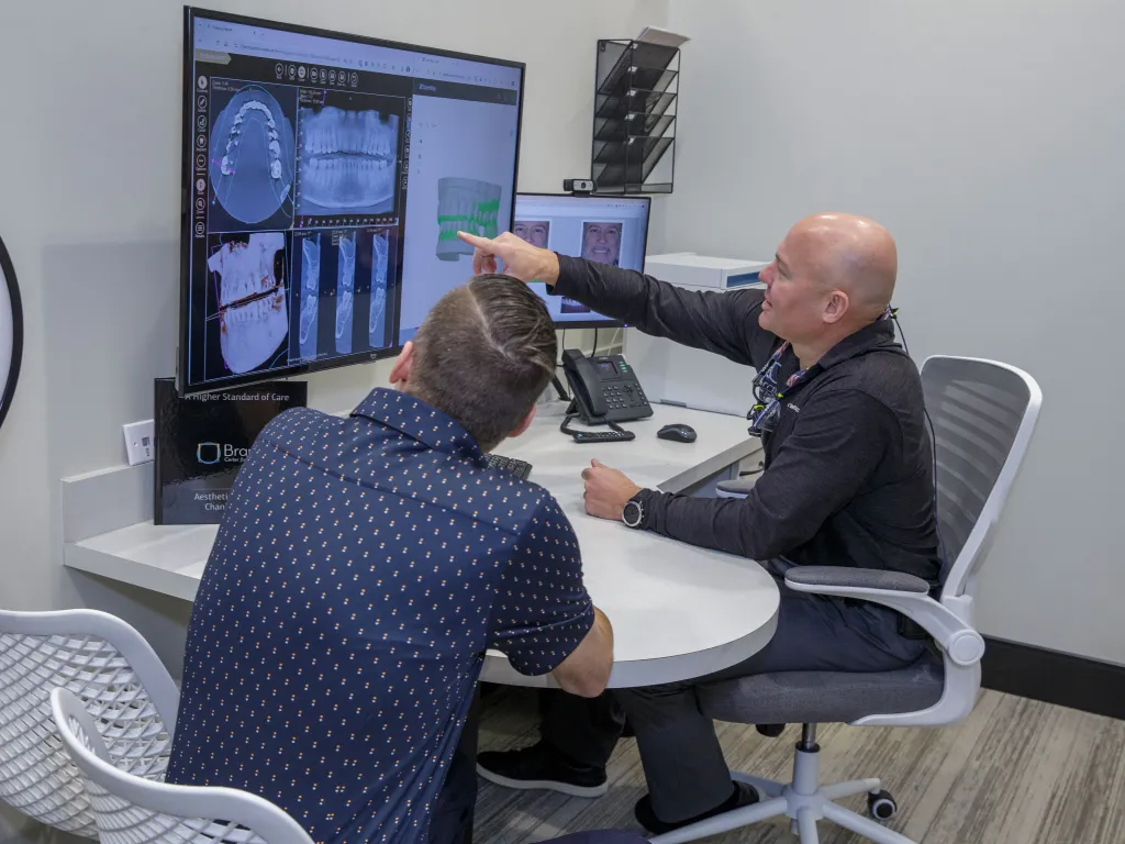 Dr. Dudley showing x-rays to a patient.
