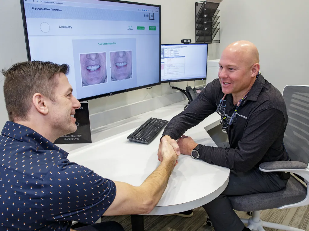 Dr. Dudley with a patient smiling.