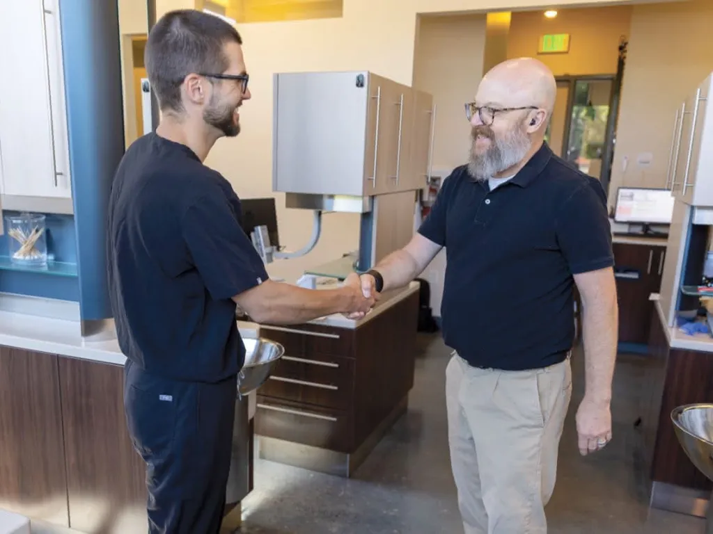 A doctor shaking hands with a patient