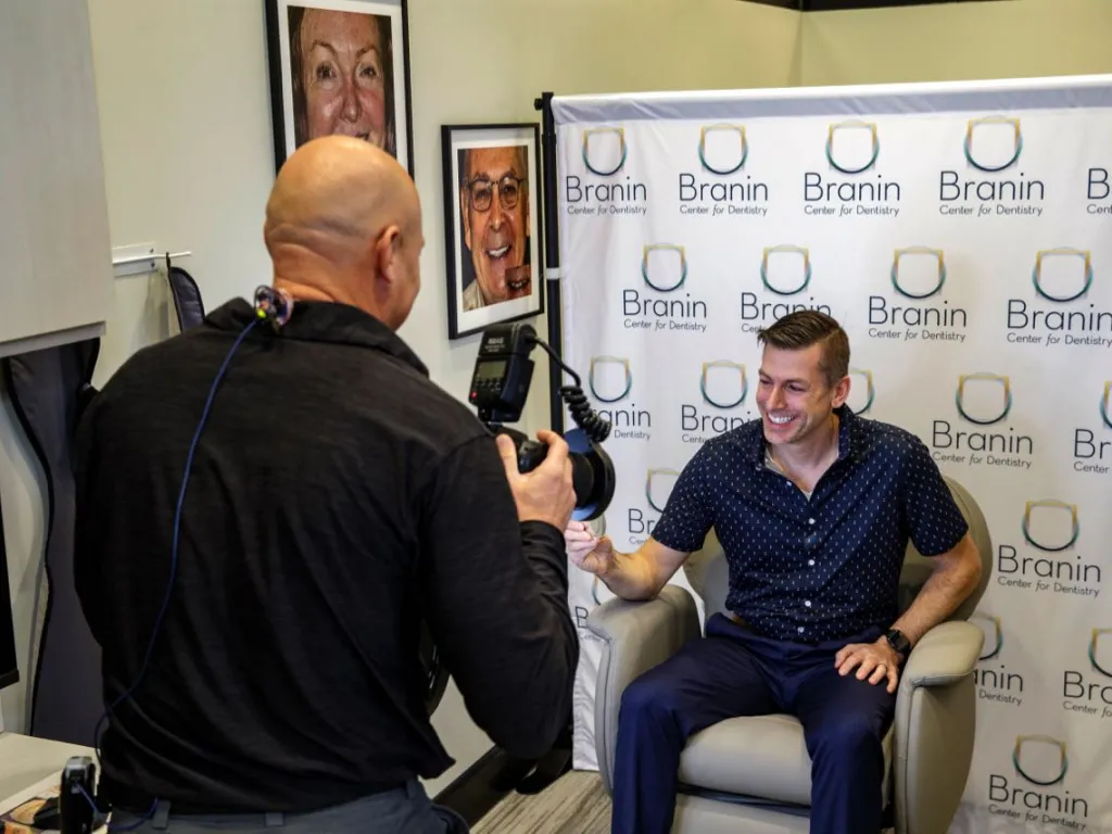 Dr. Dudley taking a photo of a patient smiling