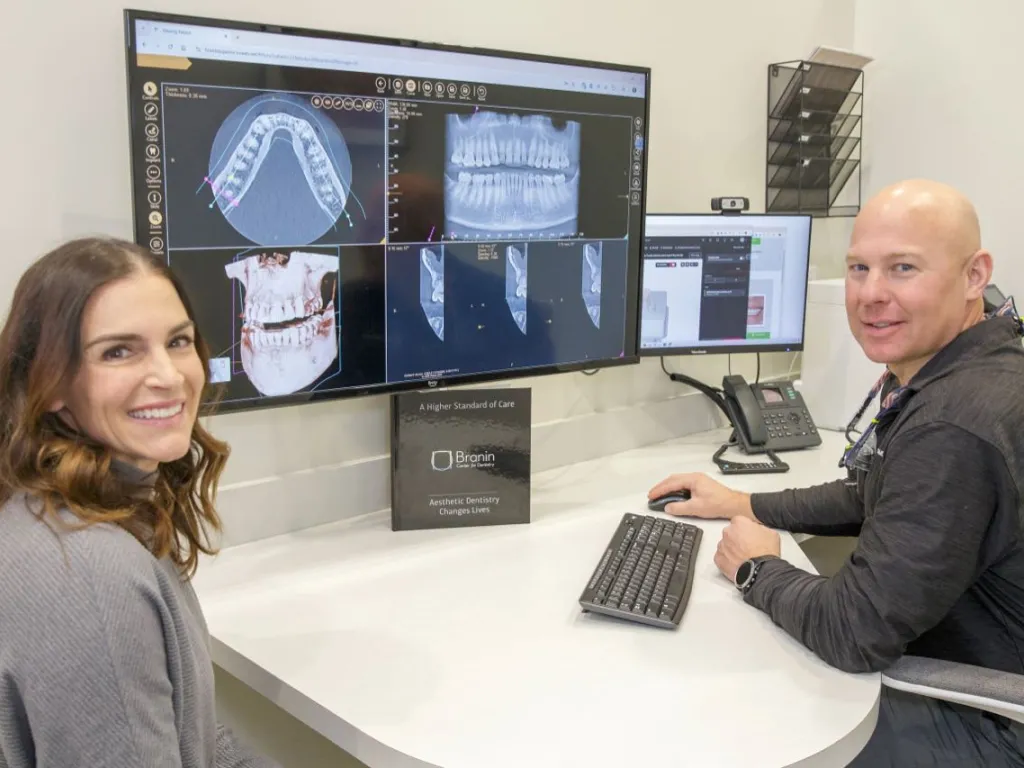 Dr. Dudley and a patient review x-rays on a compter monitor