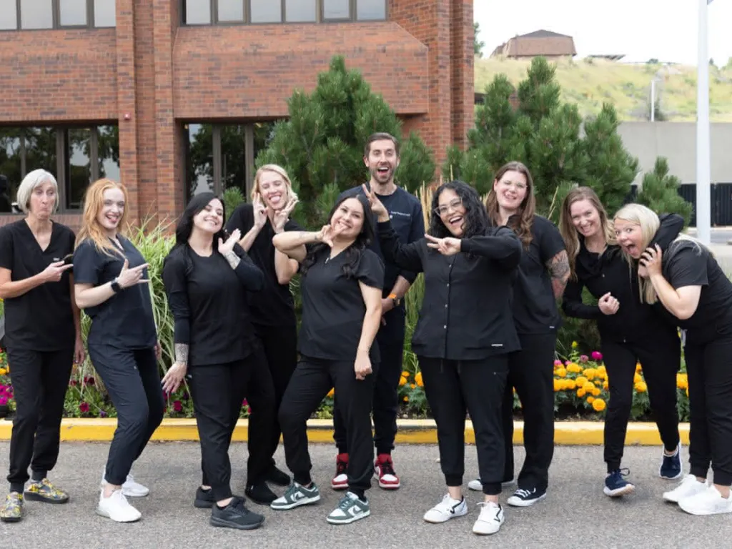 The team at Golden striking interesting poses in front of the office