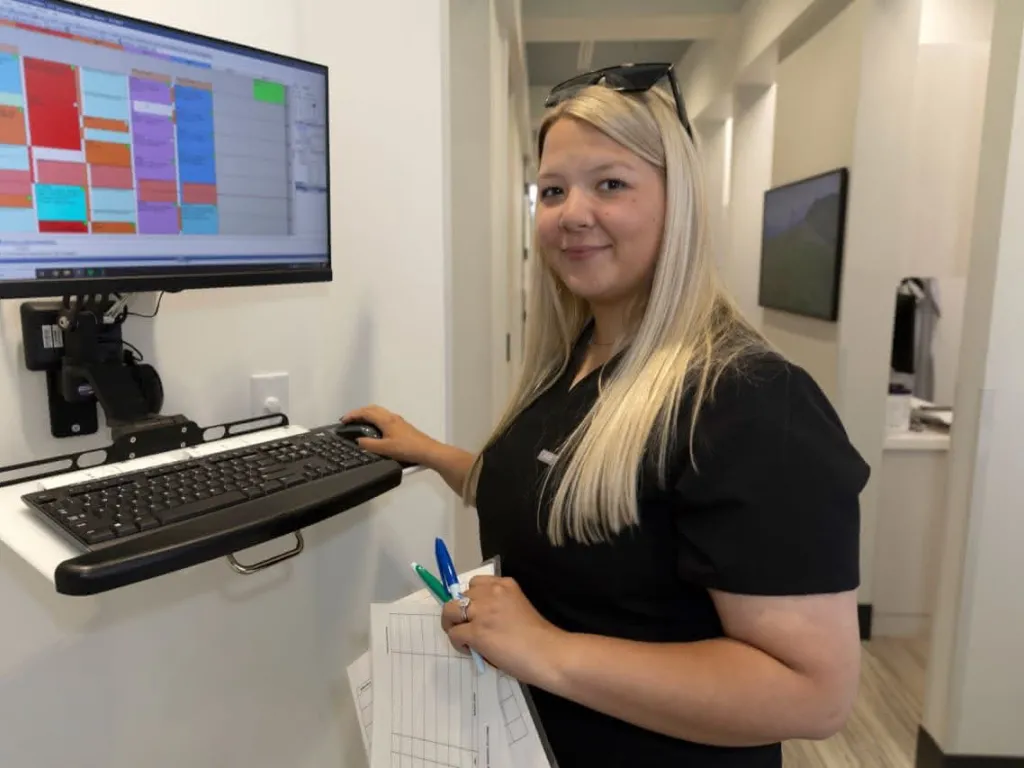A staff member reviewing schedules at a standing desk