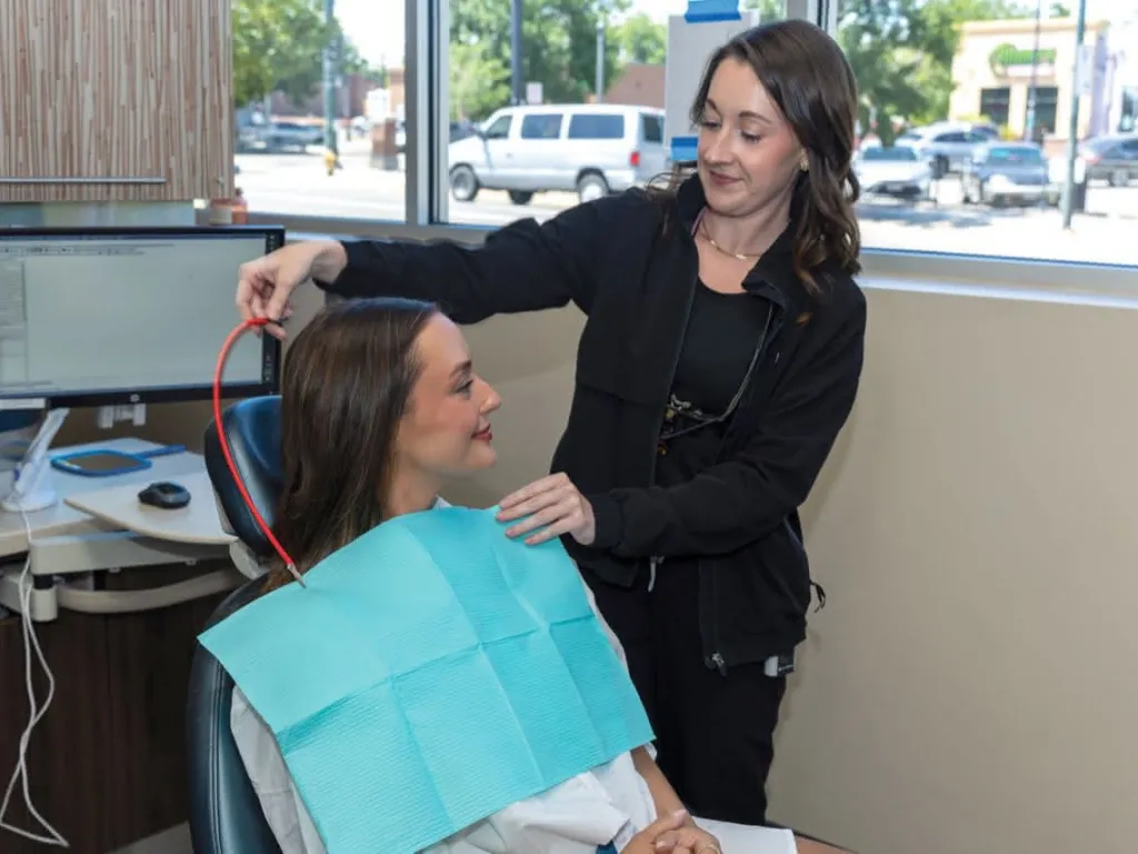 Patient in a chair with a blue bib