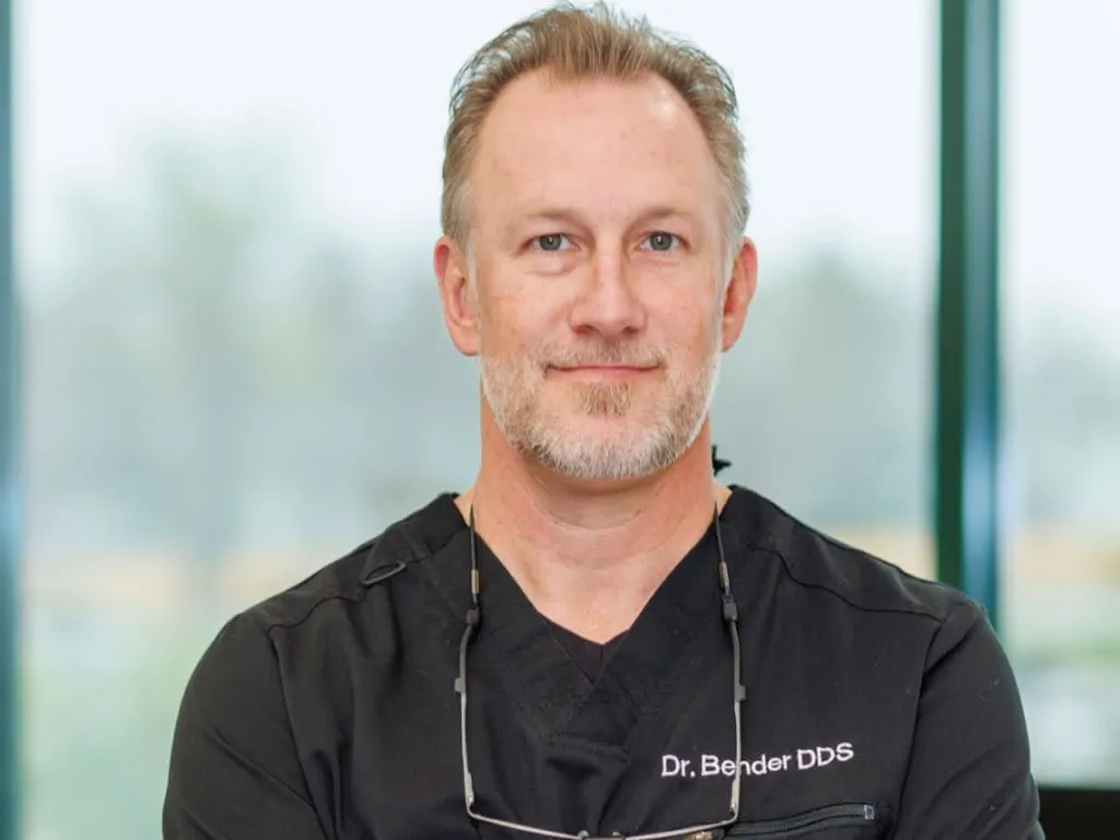 Dr. Bender in front of a window