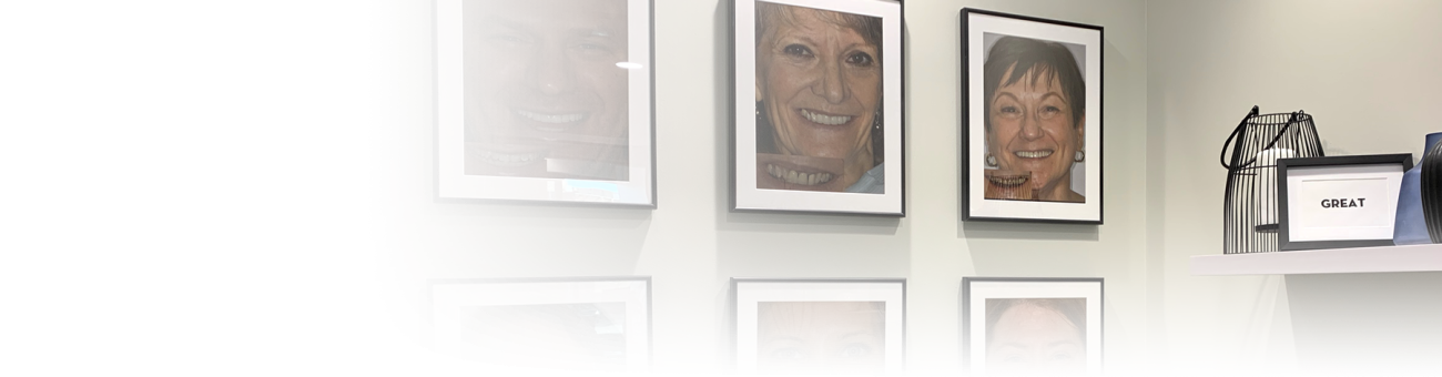 A wall full of photos of people smiling