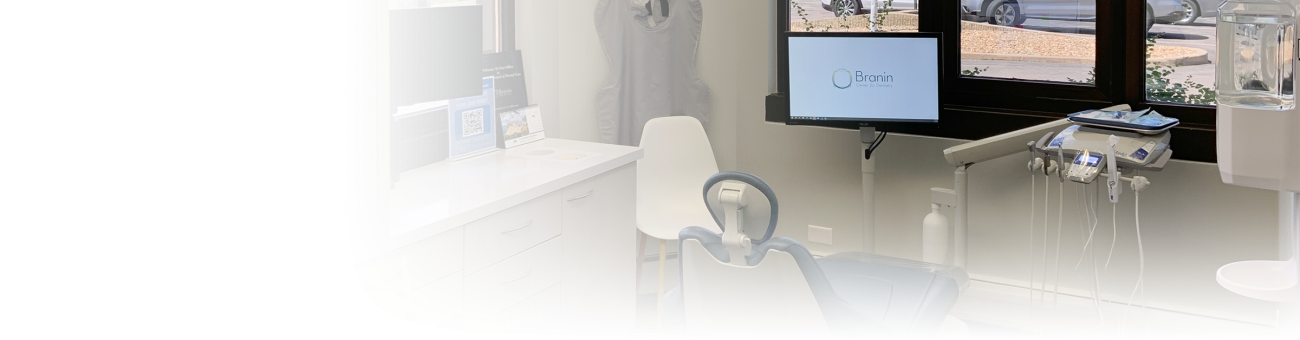 A dentist exam room with a blue chair