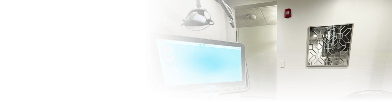 A computer monitor with a glass mirror on the wall