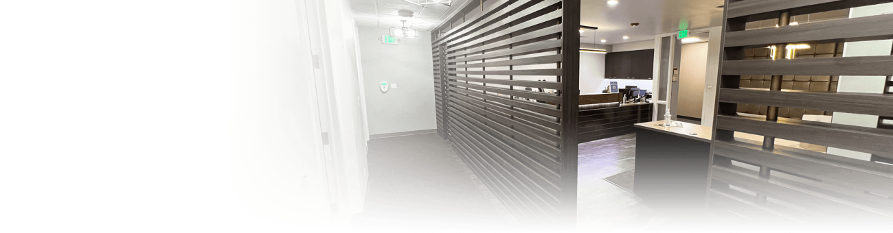 A hallway with a brown wall made with wood slats