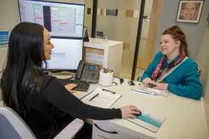 Two people discussing benefits at a desk