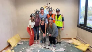 Golden staff standing in an office remodel