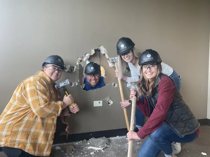 Staff taking part in demolition for the construction of Branin Center for Dentistry.