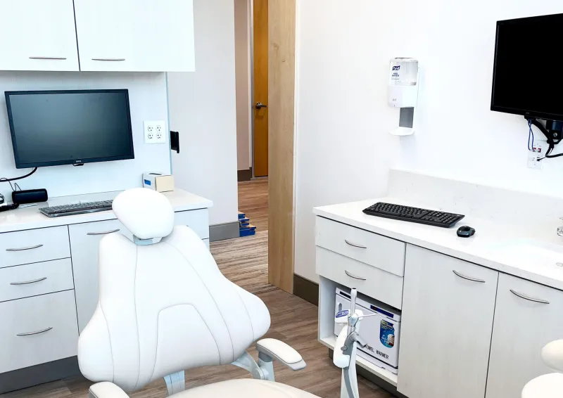 A white chair in a white dentist room