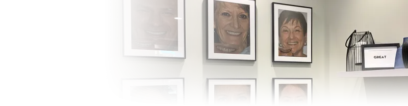 A wall full of photos of people smiling