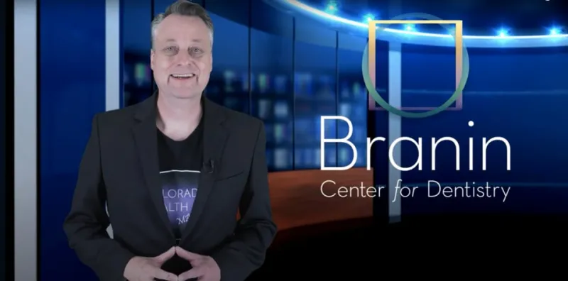 A presenter in front of the company logo