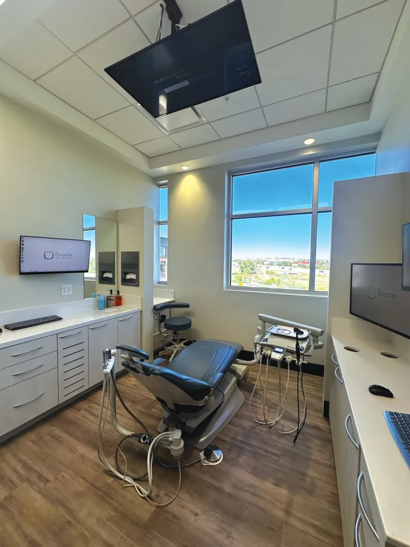 A dental chair in a room with hardwood floors