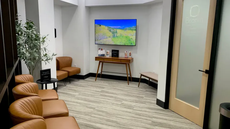 Waiting room with a large television on the wall
