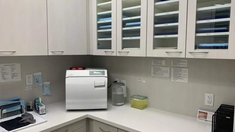 A room with medical equipment and cabinets
