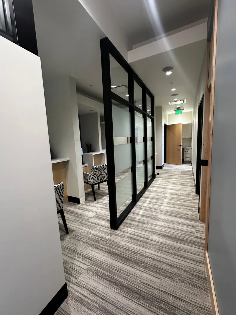 A long hallway with striped carpet