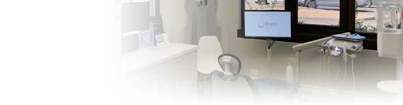 A dentist exam room with a blue chair